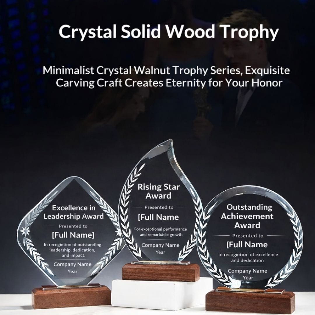 Three crystal trophies with engraved text on a dark background