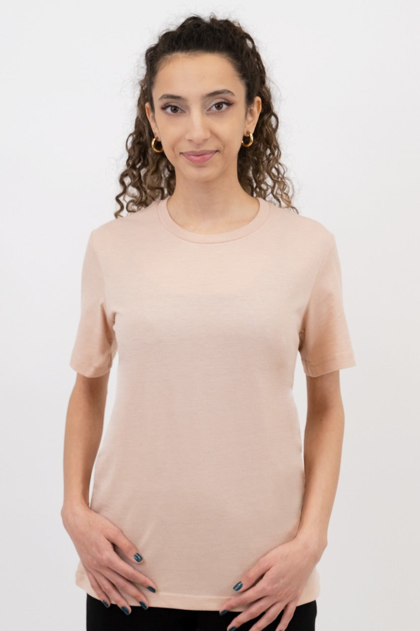 Woman wearing a beige t-shirt against a white background