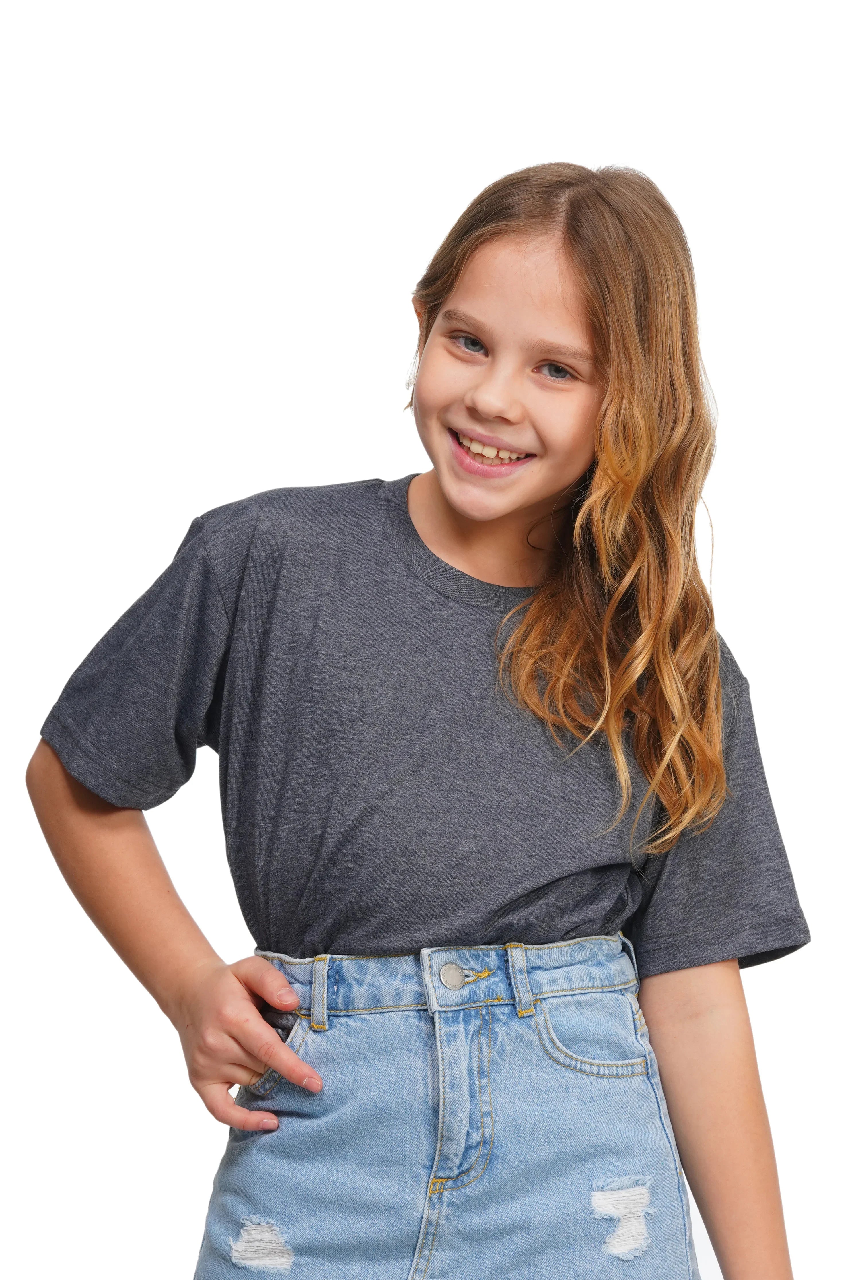 Young girl wearing a gray t-shirt and blue jeans on a white background