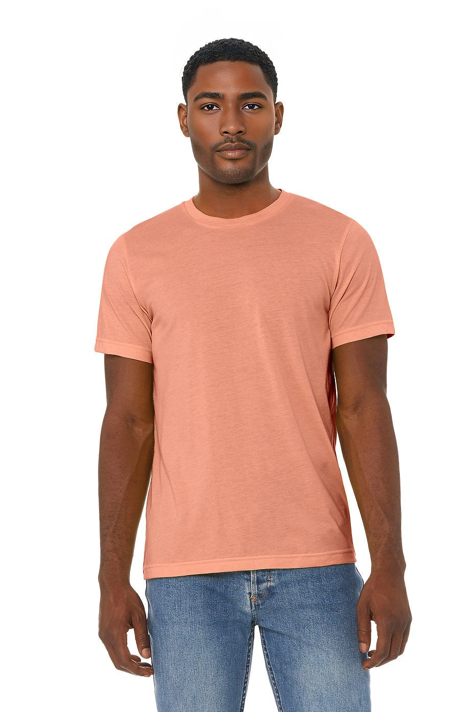 Man wearing a peach-colored t-shirt and blue jeans on a white background