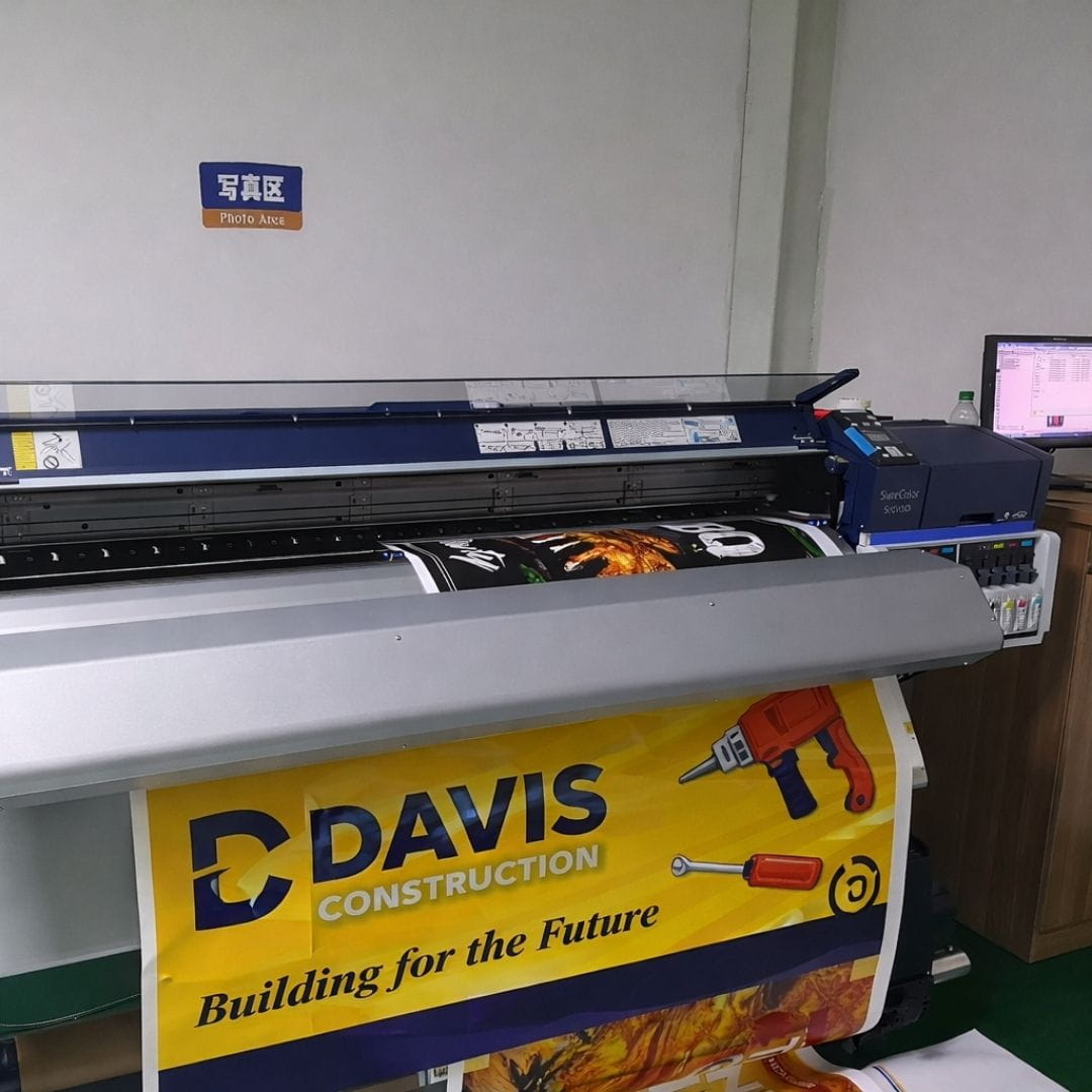 Large printing machine with a Davis Construction banner underneath