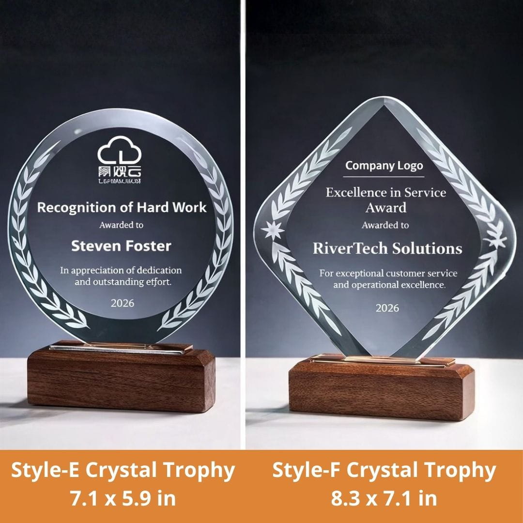 Two crystal trophies with engraved text on a dark background