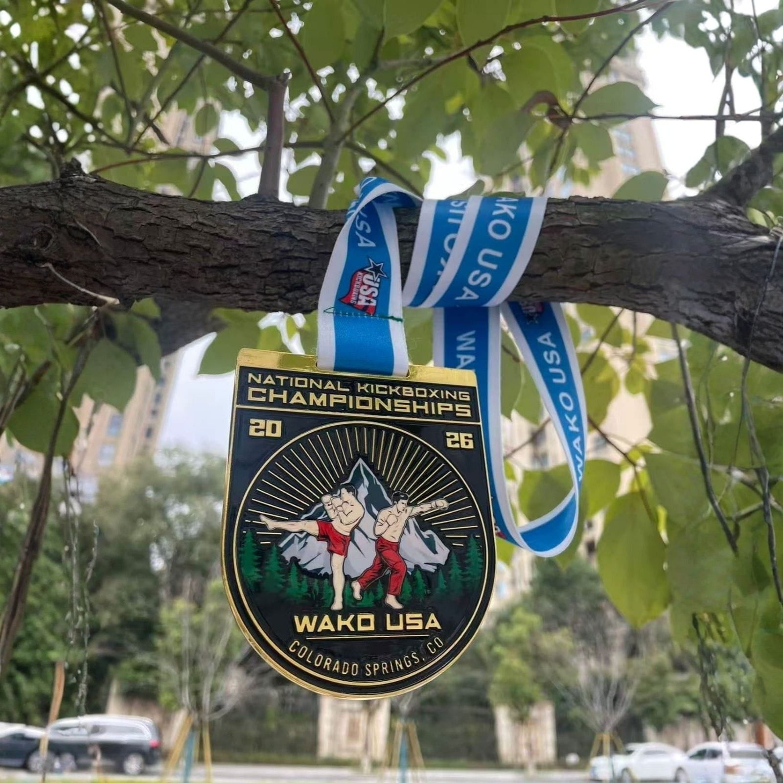 Medal with Wako USA branding hanging on a tree branch