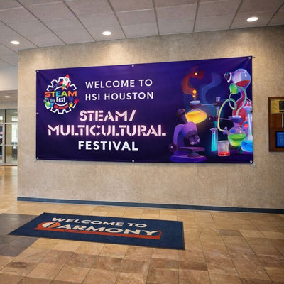 Banner welcoming to HSI Houston STEAM Multicultural Festival on a wall.