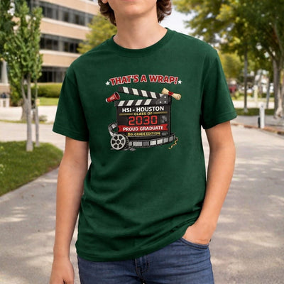 Person wearing a green t-shirt with a graduation design outdoors.