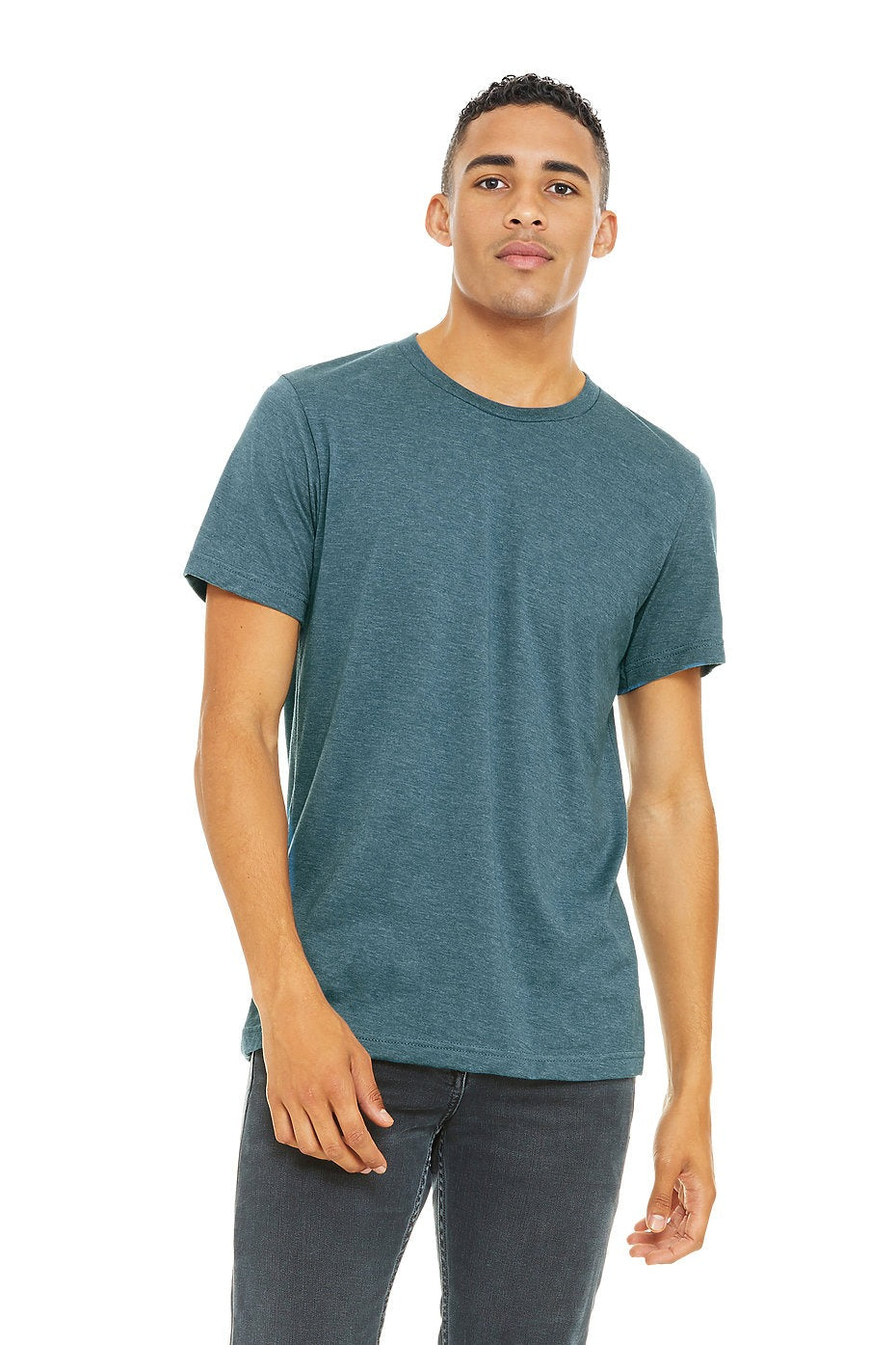 Man wearing a teal t-shirt and dark jeans on a white background