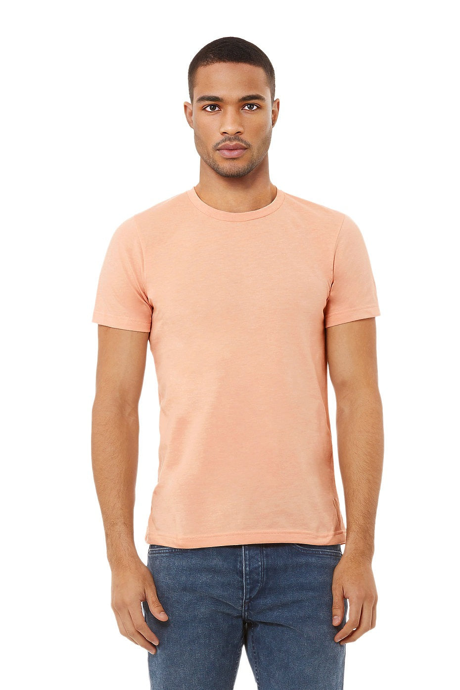 Man wearing a peach t-shirt and blue jeans on a white background