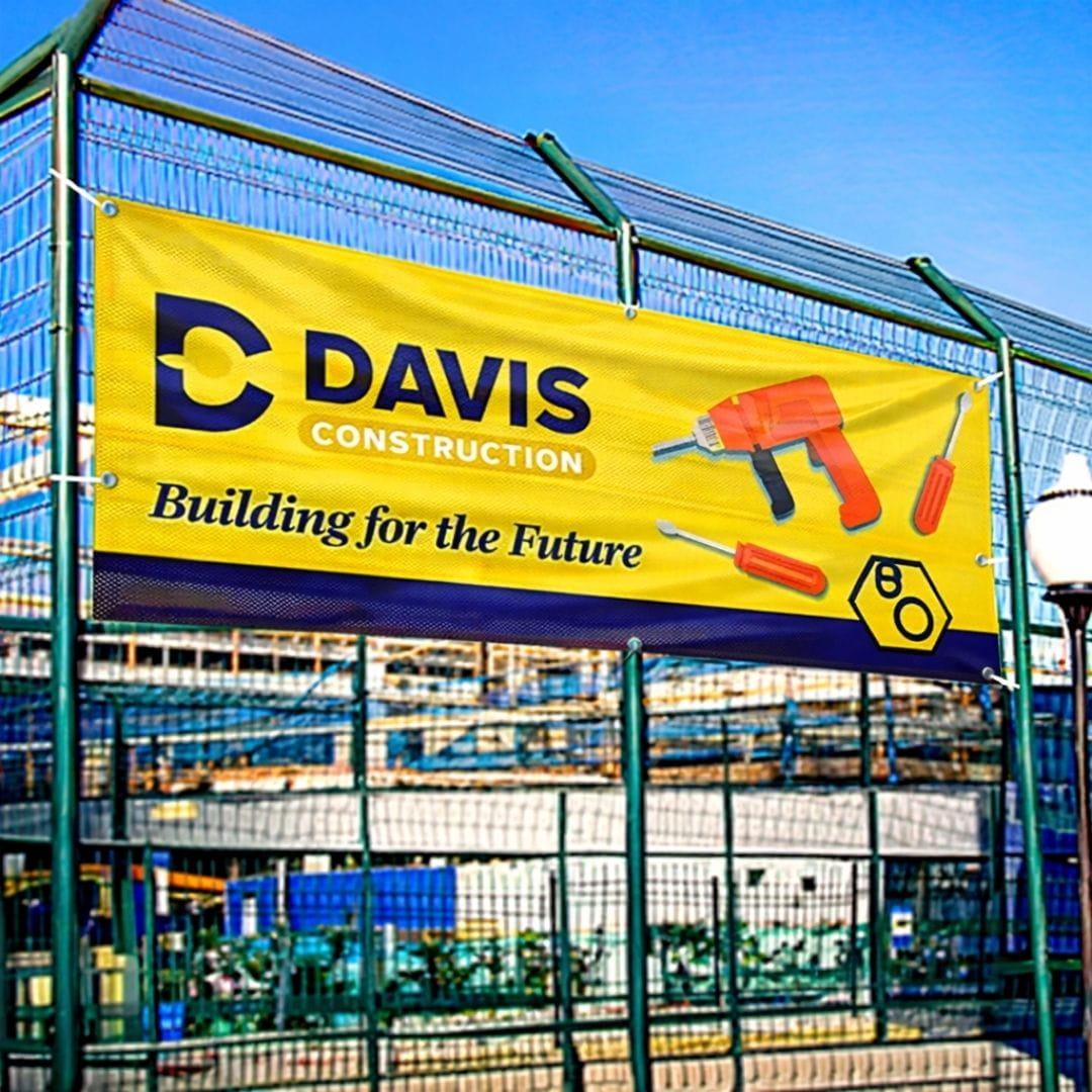 Davis Construction banner on a fence with construction tools and 'Building for the Future' text.