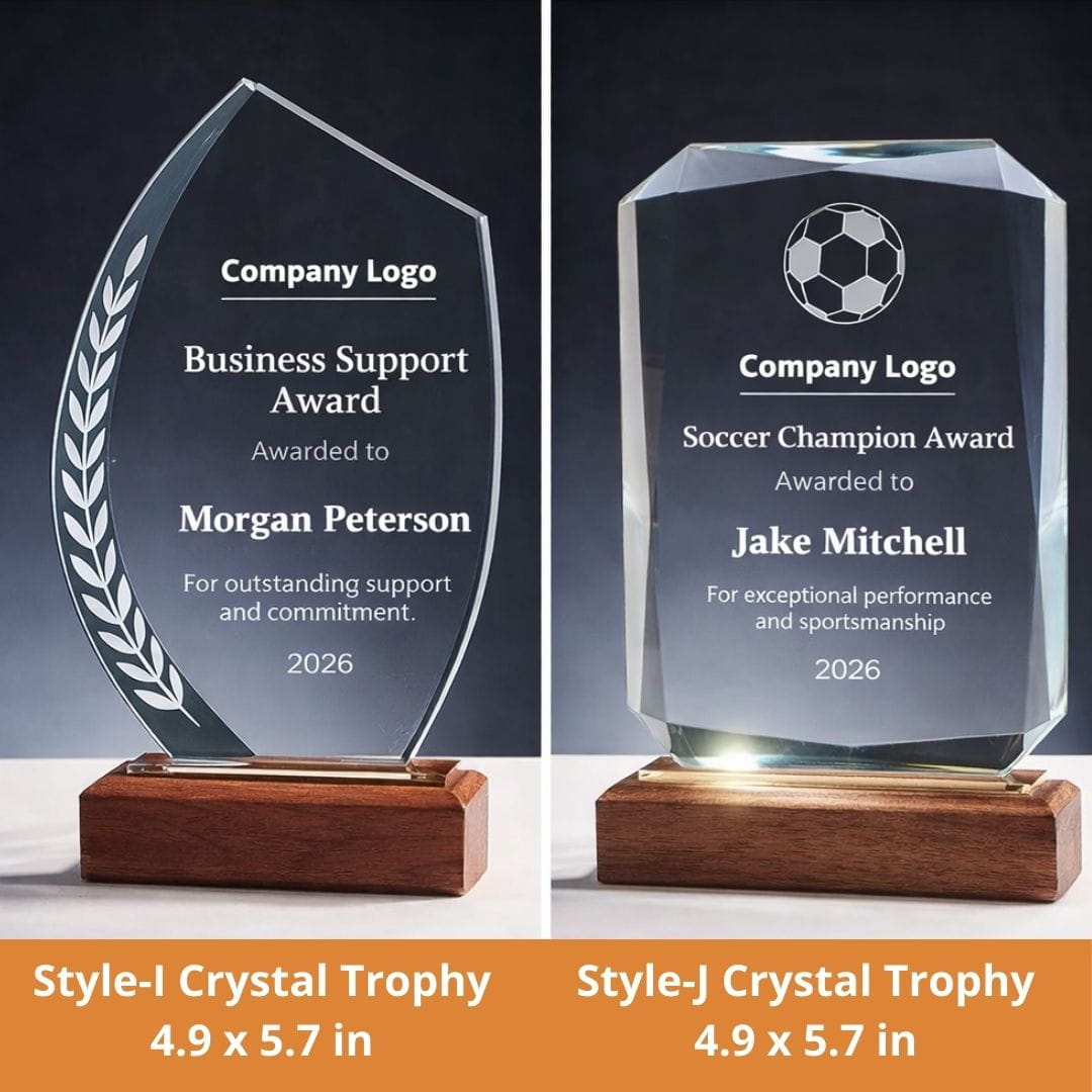 Two crystal trophies with engraved text on a dark background